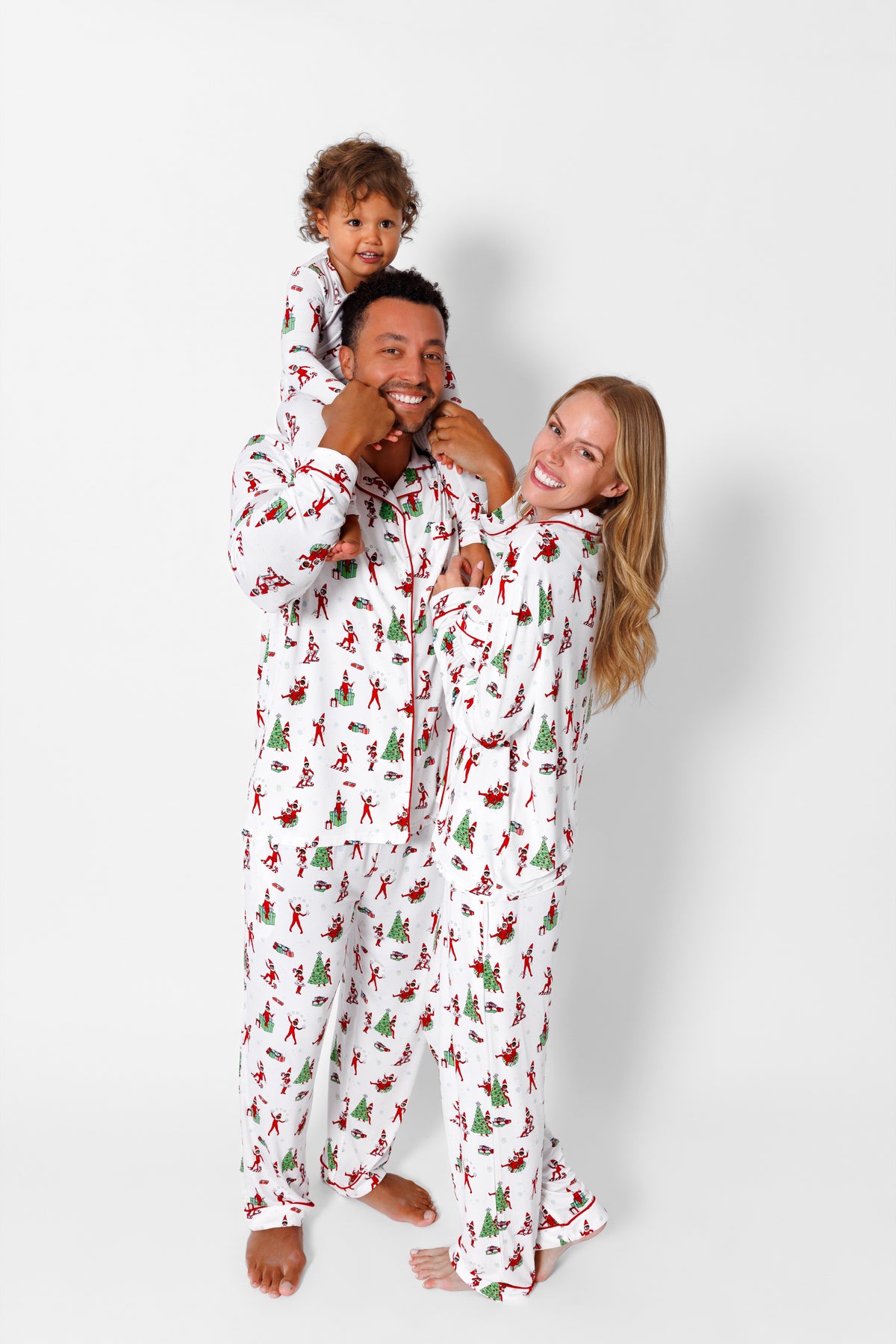 Parents and toddler in matching The Elf on the Shelf pajamas